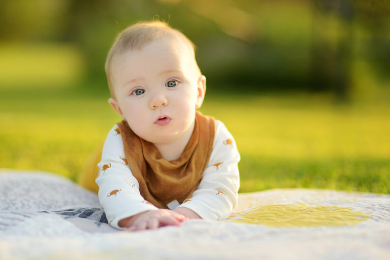 Cute Five Months Old Baby Boy Lying On His Tummy On A Blanket In New