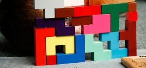 a boys eye looks through colored 3 D montessori learning blocks