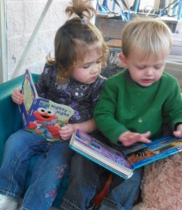 Two toddlers reading