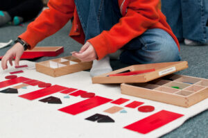 child working on grammar materials in a Montessori classroom