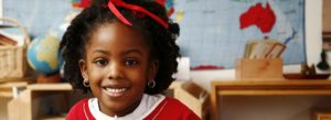 african american girl smiling with map in background