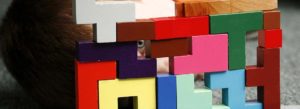 boy's eye looking through montessori blocks