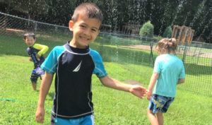 children playing in sprinkler