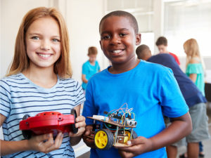 two students showing a robot project together