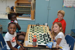 four children playing chess