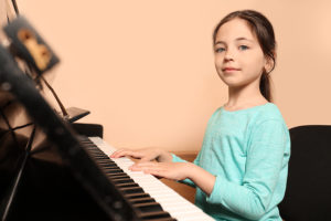 girl playing piano