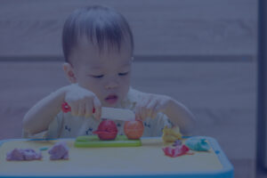 infant using wooden cutting materials