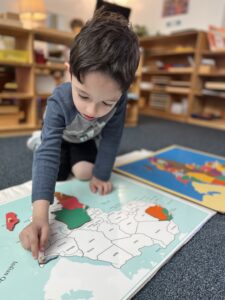 boy working with geography materials