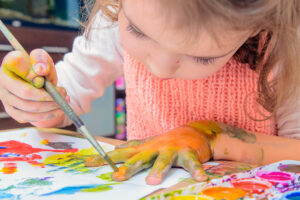 girl playing with art materials