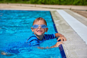 boy swimming with goggles