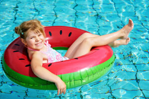 girl floating on ring in pool