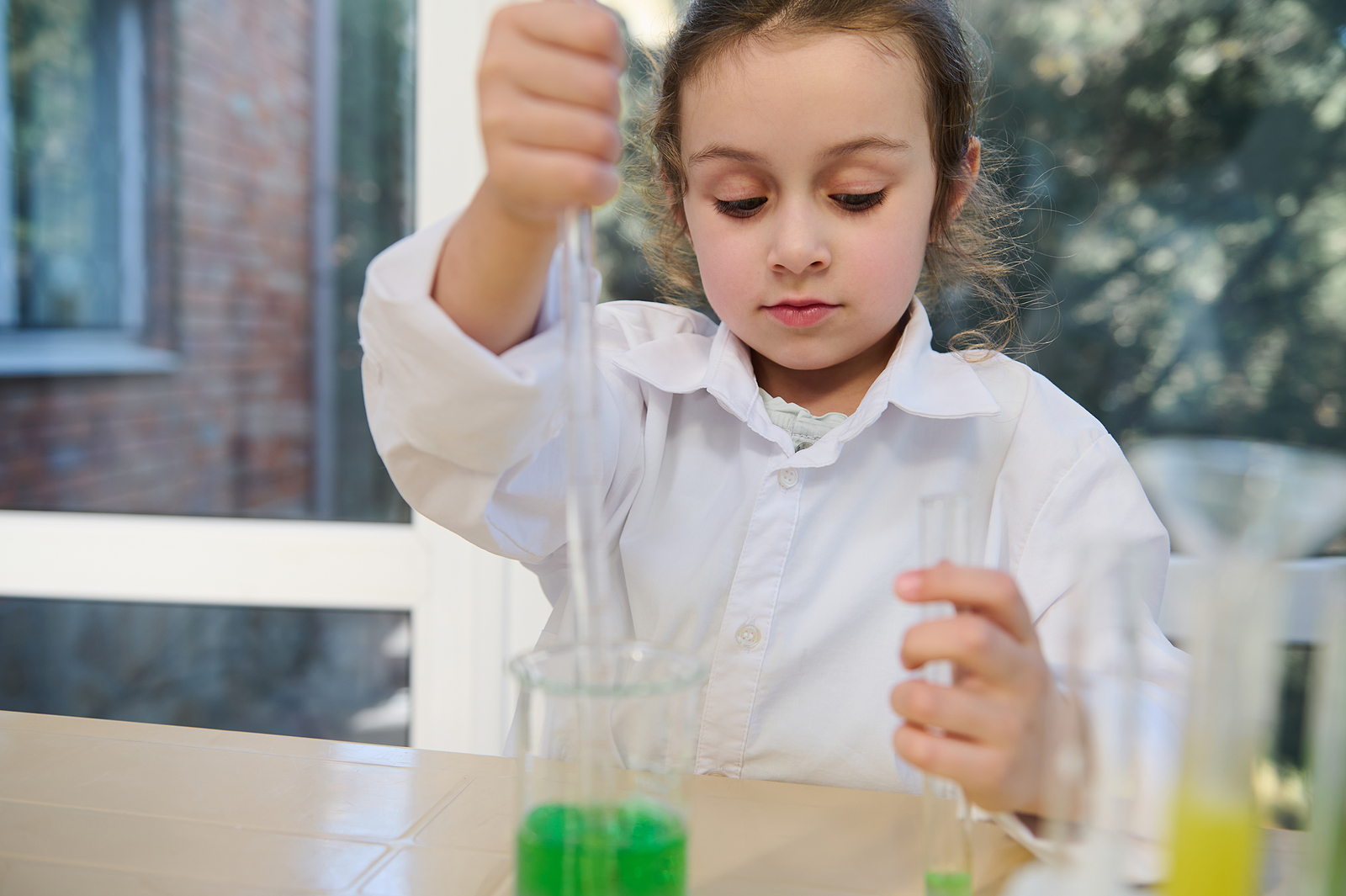 little-girl-first-grade-student-at-chemistry-class-using-gradu-new