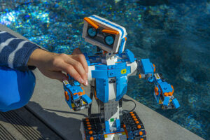 Boy using robot with Lego Engineering