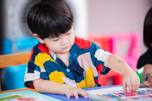 Young boy working with art materials