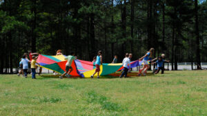 outdoor image with children pulling a parachute