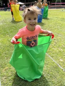 a boy playing in the sack race at sports day