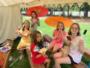 girls enjoying summer camp with colonial times theme