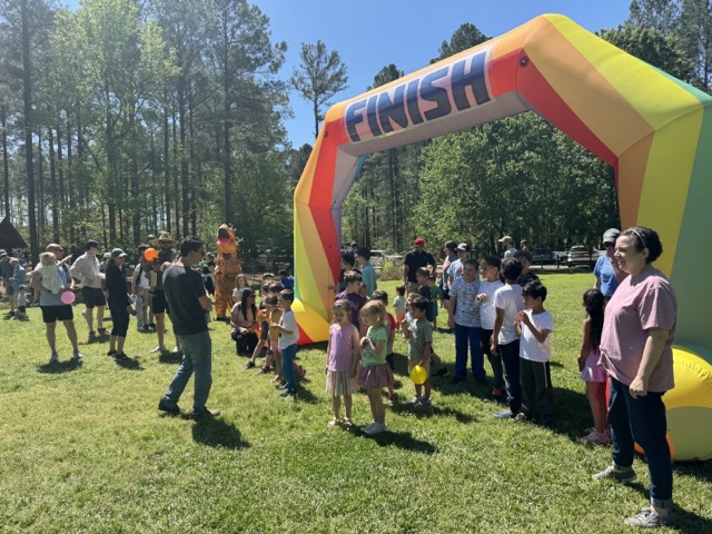 Group of parents and children gathered at the Spring Fling Picnic for The New School