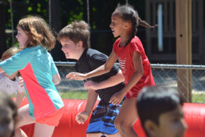 elementary aged children playing at field day at The New School